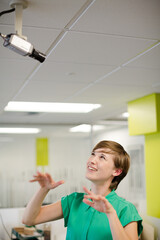 Businesswoman making face at security camera