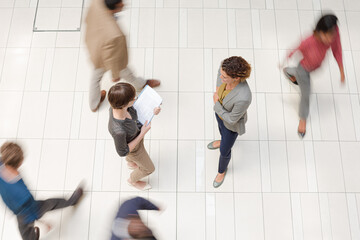 Business people in busy office hallway
