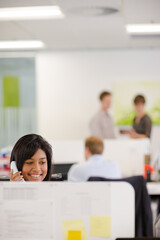 Fototapeta premium Businesswoman talking on phone at desk
