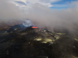 Fototapeta premium Impressive aerial view of the exploding red lava from the Active Volcano in Iceland