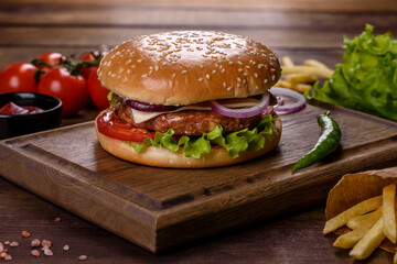 Craft beef burger and french fries on a black background