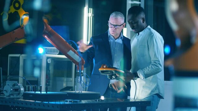 Engineering colleagues are operating a robot together