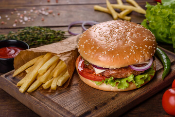 Craft beef burger and french fries on a black background
