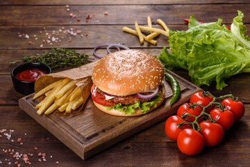 Craft beef burger and french fries on a black background