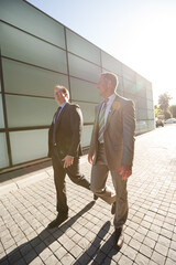 Businessmen walking on city street