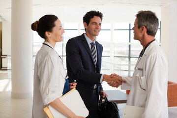 Doctor sitting on floor in hospital corridor