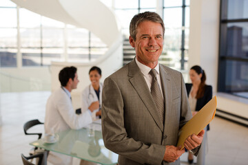 Doctor carrying folders in hospital