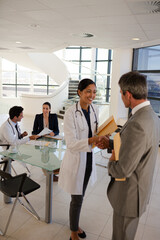 Doctor and businessman shaking hands in meeting