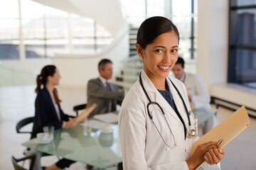 Doctor carrying folders in hospital