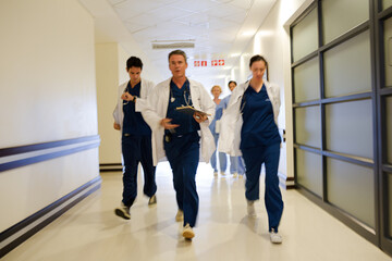 Doctors rushing down hospital corridor