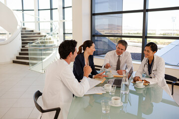 Portrait of smiling nurse with senior patient in background