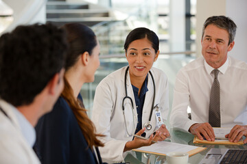 Doctors rushing down hospital corridor