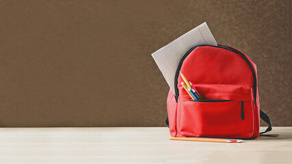 Red children's briefcase with pencils, ruler, notebook for writing, school on September 1