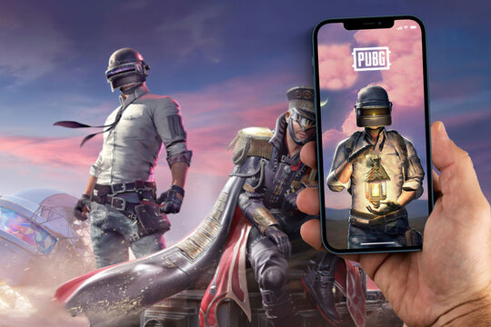 Male hand holding a smartphone with Player's Unknown Battleground, PUBG mobile game App on the screen. The game blurred on background. Rio de Janeiro, RJ, Brazil. August 2021.
