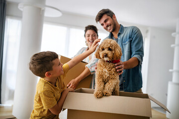 Happy family unpacking boxes in new home on moving day - obrazy, fototapety, plakaty