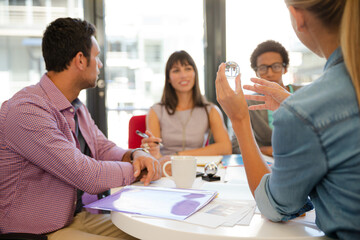 Business people examining model in meeting