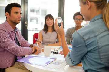 Business people examining model in meeting