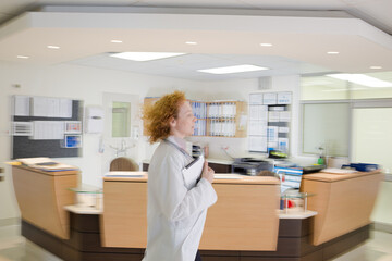 Doctor rushing in hospital hallway