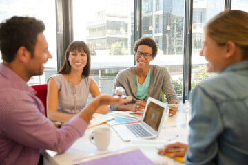 Business people examining model in meeting