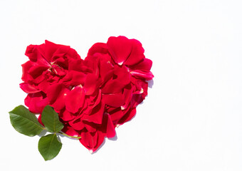 A heart made of red rose petals on a white background with space for text.A postcard, a banner.
