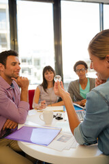 Business people examining model in meeting