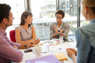 Business people examining model in meeting