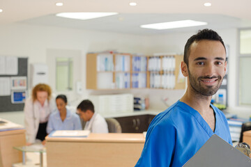 Doctor smiling in hospital hallway