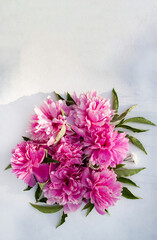 Pink peonies on a light background with space for text. Postcard.