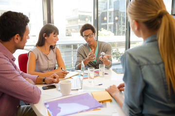 Business people examining model in meeting