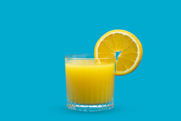 Healthy orange juice with fresh fruit on blue background