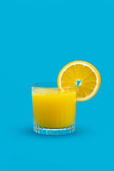 Healthy orange juice with fresh fruit on blue background
