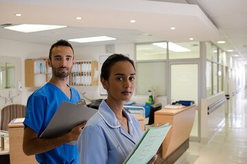 Doctor and nurse standing in hallway