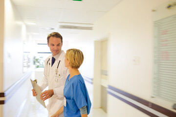 Nurse and doctor walking in hospital hallway