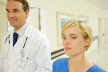 Nurse and doctor walking in hospital hallway