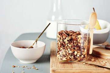 Homemade granola with nuts and raisins in a jar.