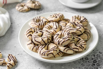 Cookies in white-black chocolate glaze on a light background