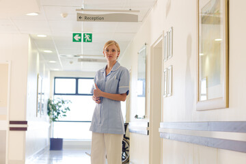 Nurse smiling in hospital hallway