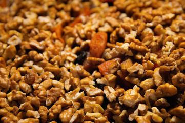 Dried mixture of walnuts and dried fruits close-up. Mix for adding to baked goods. Healthy vegan food