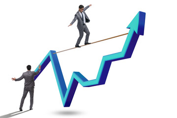 Businessman balancing on tightrope on line chart