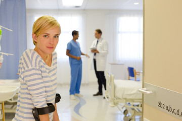 Patient using crutches in hospital room