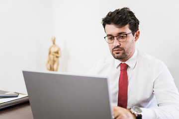 Businessman working in office with laptop and documents on his desk, consultant lawyer concept.