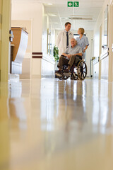 Doctor and nurse with older patient in hospital