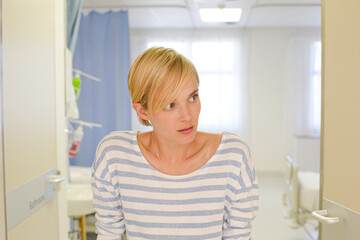 Patient using crutches in hospital room
