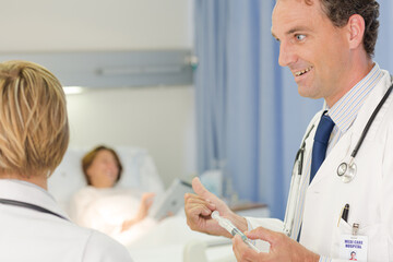 Fototapeta premium Doctor checking syringe in hospital room