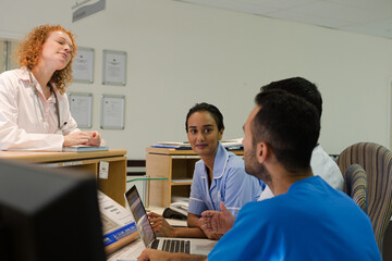 Fototapeta premium Hospital staff talking at front desk