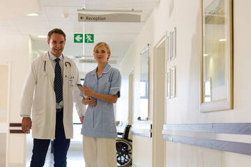 Doctor and nurse standing in hallway