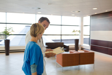 Doctor and nurse talking in hospital hallway