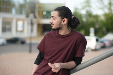 Close up portrait of handsome Arab man walking in the park