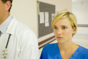 Nurse and doctor walking in hospital hallway