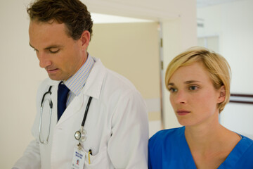 Nurse and doctor walking in hospital hallway